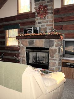The Great Room and cozy fireplace of the Chickasaw Log Cabin