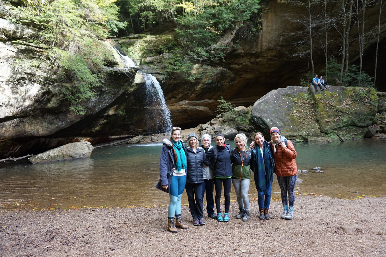 group in front of water fall