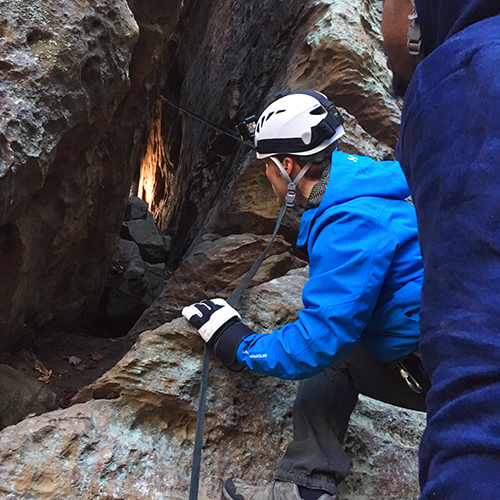 man look into rock formation